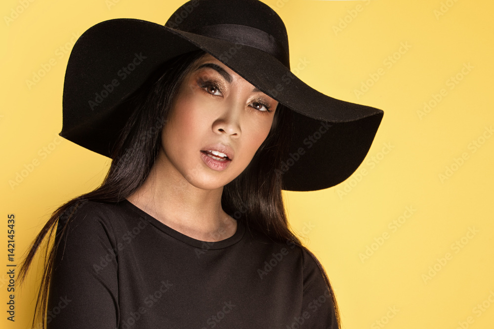 Fashionable young asian girl in hat. Fashionable young asian girl in hat.