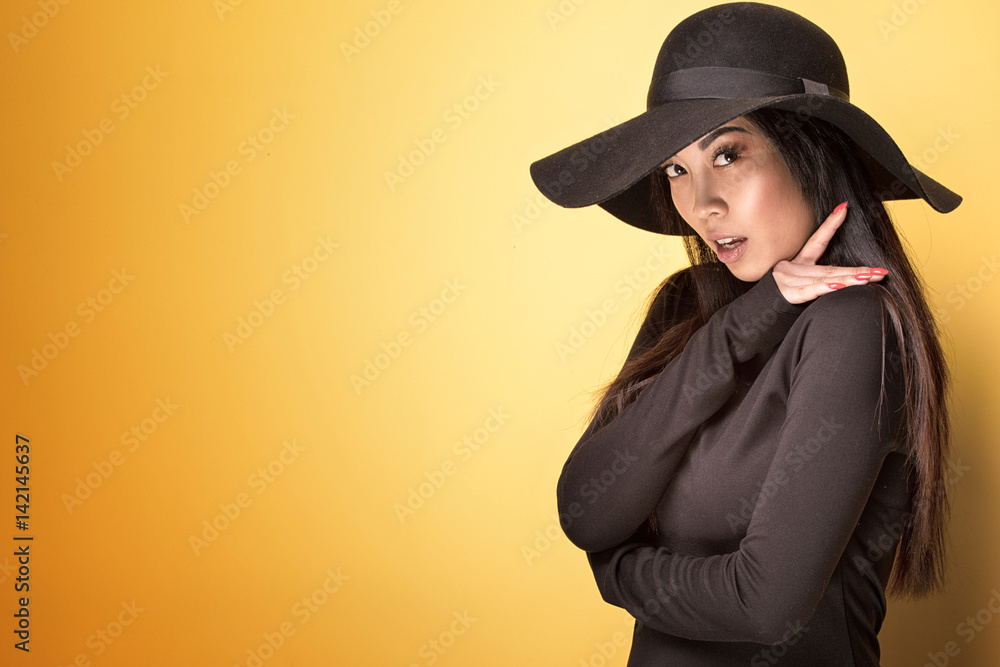 Fashionable young asian girl in hat. Fashionable young asian girl in hat.
