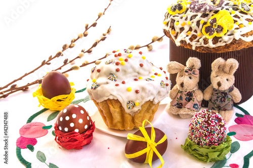 Easter composition with cakes, funny toy rabbits and eggs.