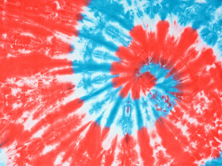 close up shot of red, white and light blue color tie dye fabric texture background
