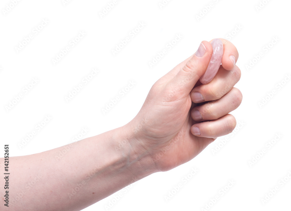 Young woman's hand holding rose quartz worry stone isolated on white background Young woman's hand holding rose quartz worry stone isolated on white background