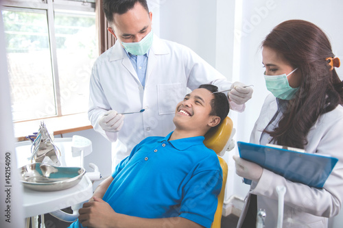 dentist talking to his patient at dental care clinic