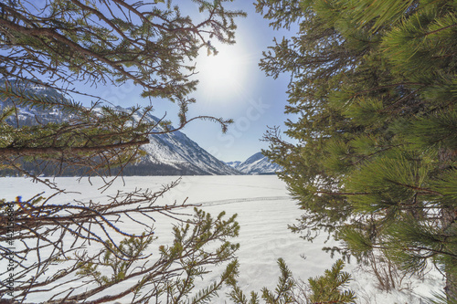 Lower Multinsky lake under snow, a sunny day photo