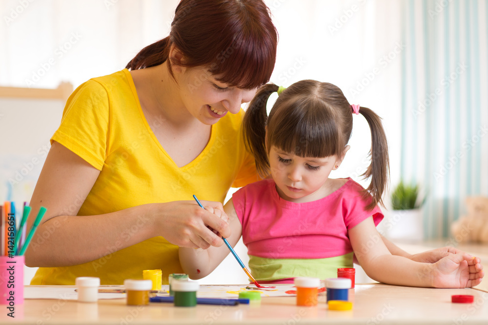 cute mother teach her daughter kid to paint cute mother teach her daughter kid to paint