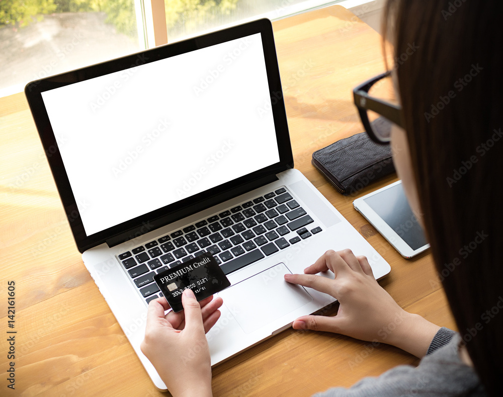 woman of business man hand working on laptop computer on wooden desk Laptop with blank screen on table. woman of business man hand working on laptop computer on wooden desk Laptop with blank screen on table.