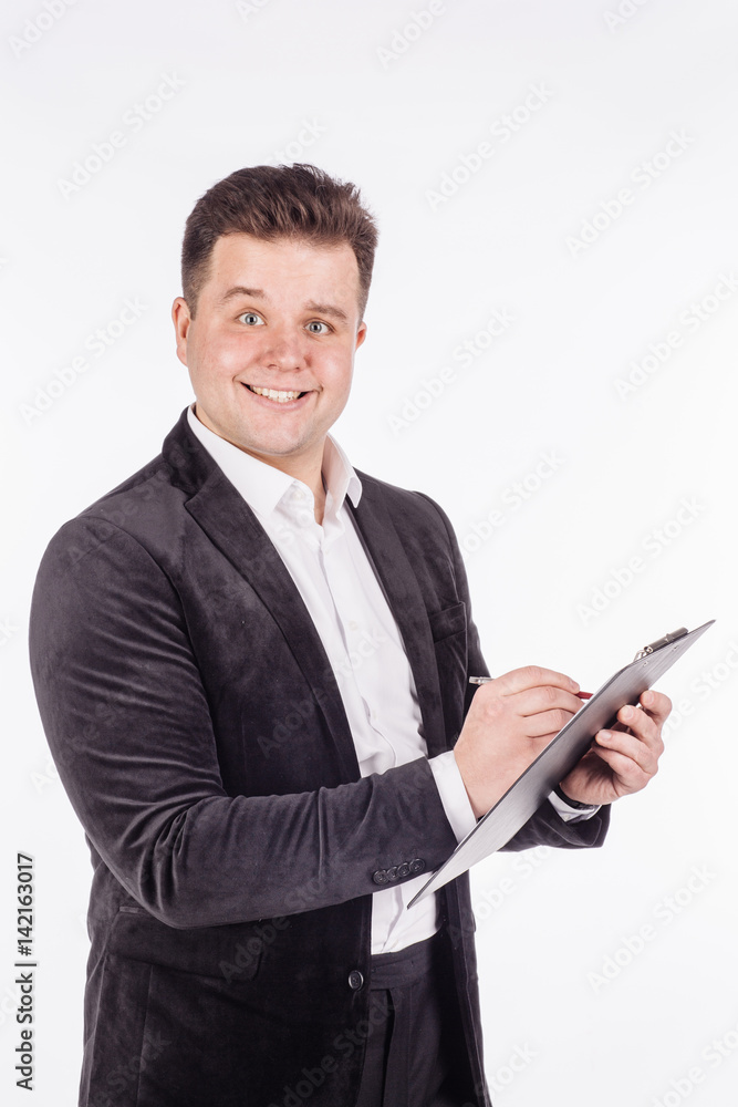young business man standing and writing in folder on a white background.