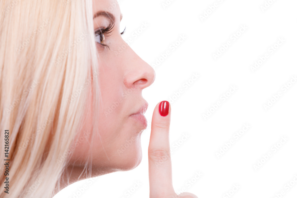 Attractive blonde woman making silence gesture Attractive blonde woman making silence gesture