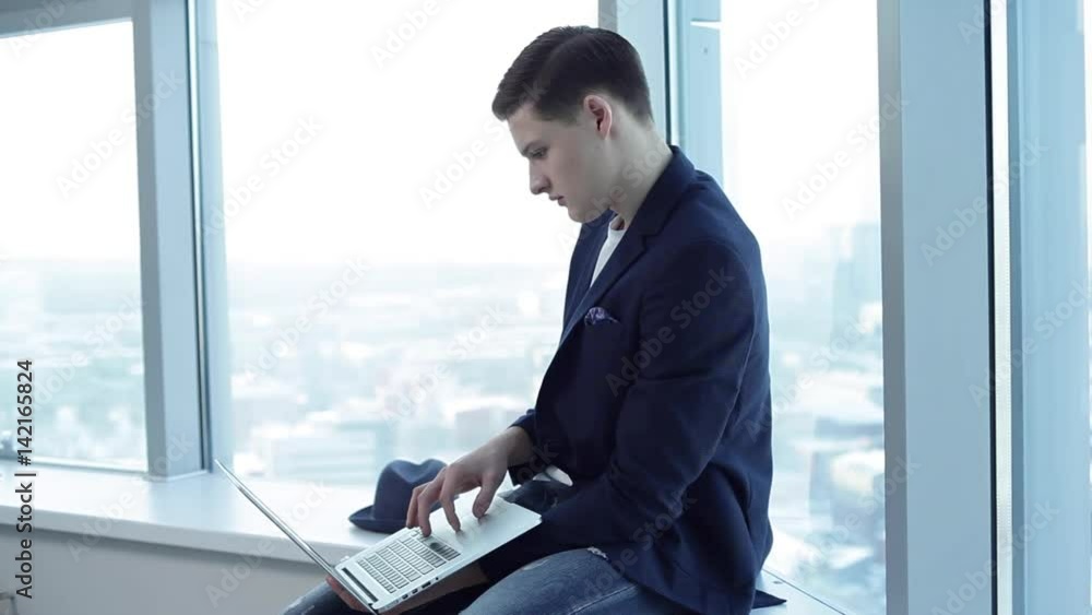 Student With Laptop at the University/Student with laptop is going to defend his project for a business center design Student With Laptop at the University/Student with laptop is going to defend his project for a business center design