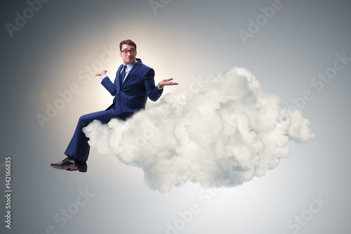 Businessman sitting on the cloud in motivitation concept