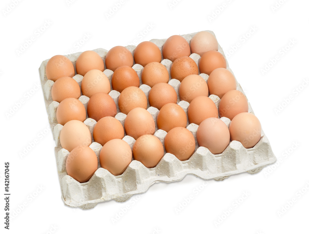 Brown eggs in the cardboard egg tray on light background