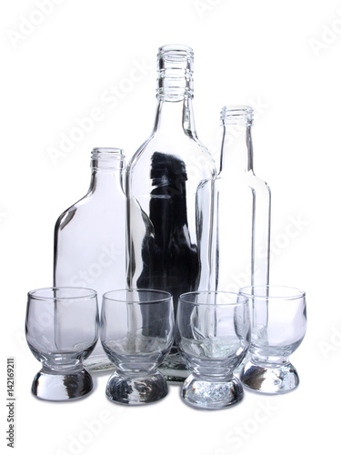 Empty glasses bottles on white background