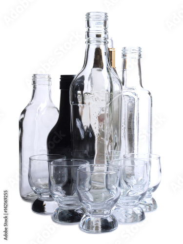 Empty glasses bottles on white background