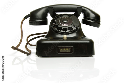 Vintage Phone, with the hook on..The telephone is really old, worn and dusty