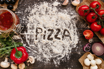 Fototapete Pizzeria Pizzazubereitung auf rustikalem Holztisch  © fedorovacz