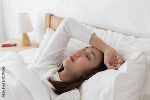 Woman have a headache after wake up in the morning