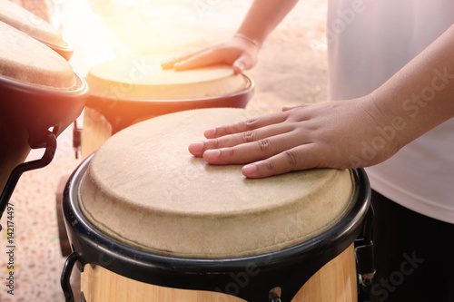 A man hitting an African drums. Man playing on drum. The drummer in action.Play on a musical instrument Drummer. (Top View)