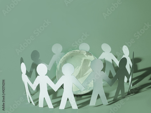 Team of paper doll people holding in hands
