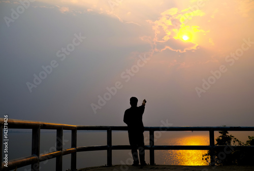 Silhouette of man on sunset. Element of design. Silhouette of man hand up on the top dam with the sunset.