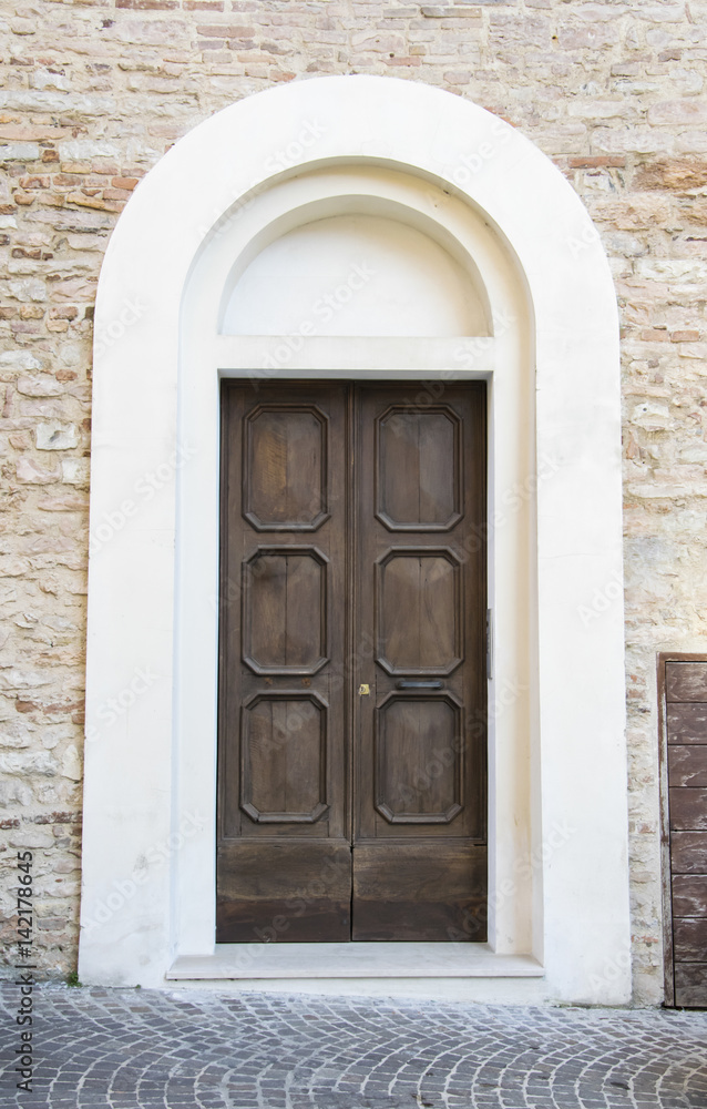 Wooden door in an old Italian house.