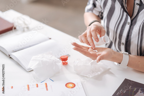 Female fingers counting medicine on the palm