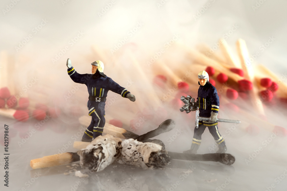 Fototapeta premium Fire fighters at work in dense smoke - miniature models