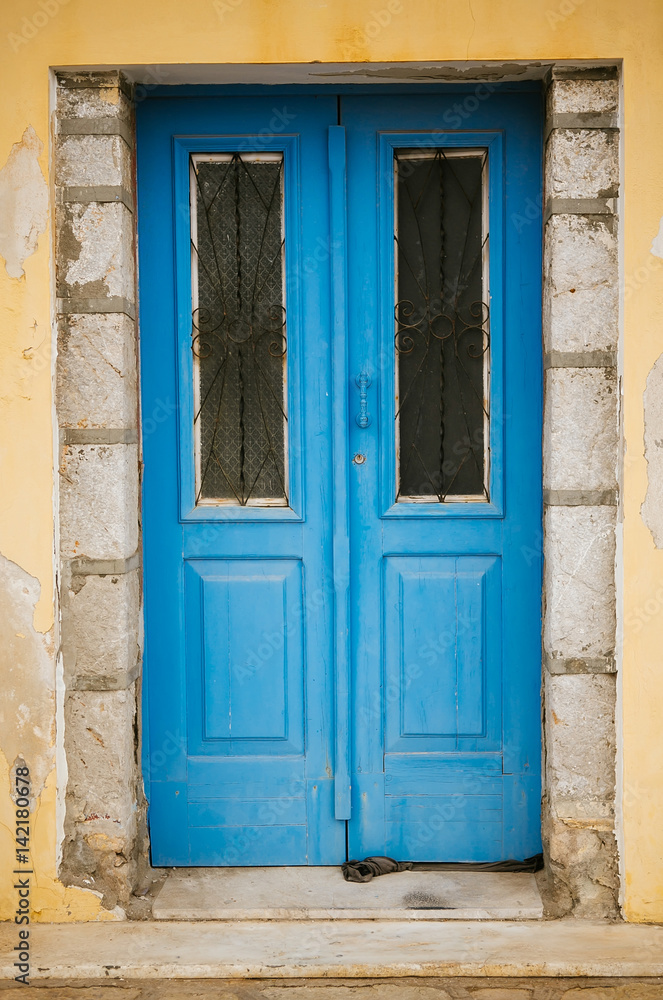 Blue old door with glass and forging