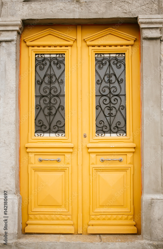 Yellow door with glass and wrought Yellow door with glass and wrought