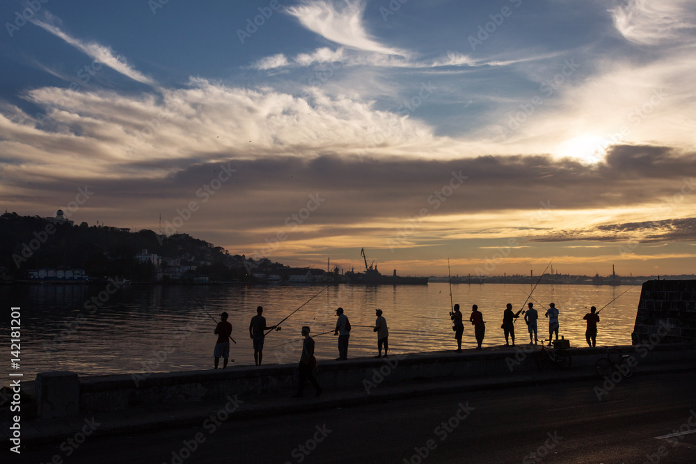 Fisher men fishing on sunrise in Havana, Cuba