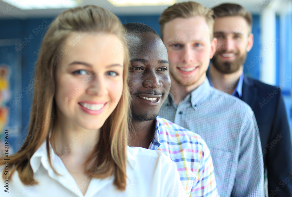 Happy smiling business team standing in a row at office