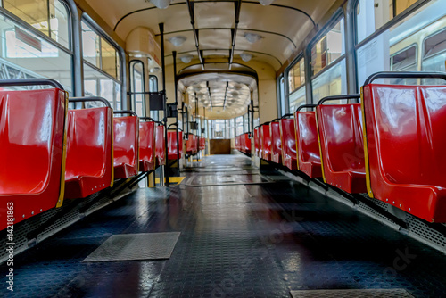 Interior of the old tram with red seats. Shallow depth of field.