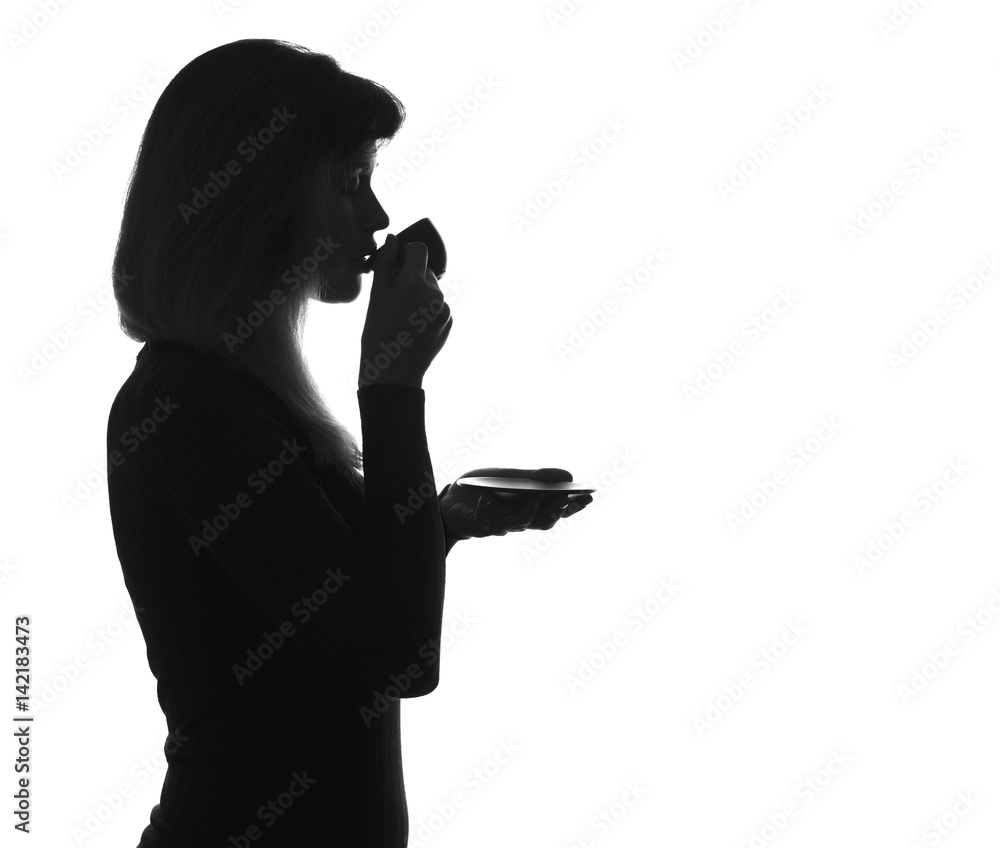 silhouette of young woman drinking coffee