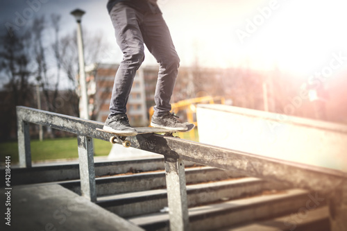 Skater doing frontside boardslide down the rail © guteksk7