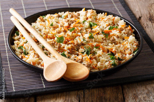 Fried spicy rice with minced meat and vegetables close-up. Horizontal