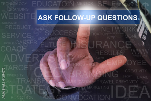Businessman touching ASK FOLLOW-UP QUESTIONS button on virtual screen