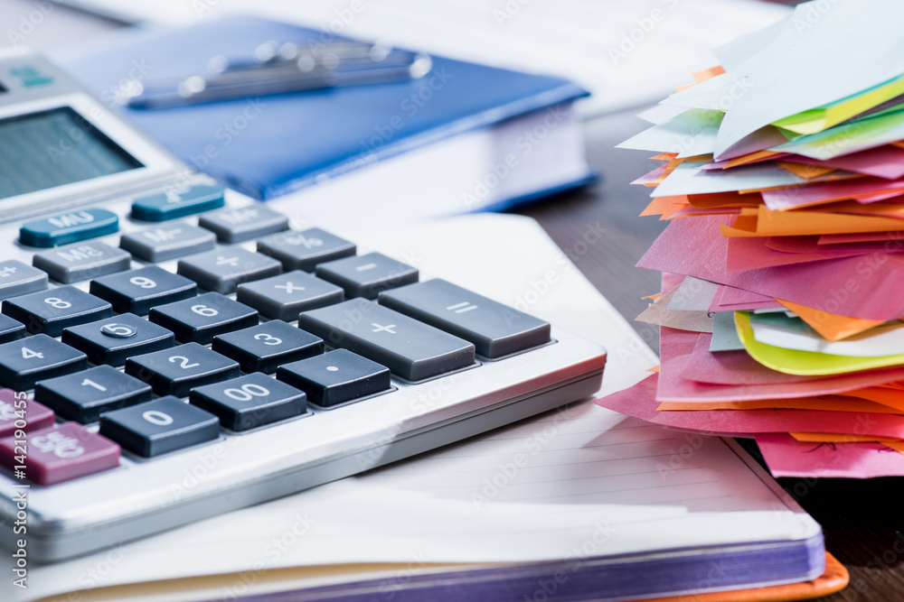 Close-up view of calculator, notebook and office supplies at workplace Close-up view of calculator, notebook and office supplies at workplace