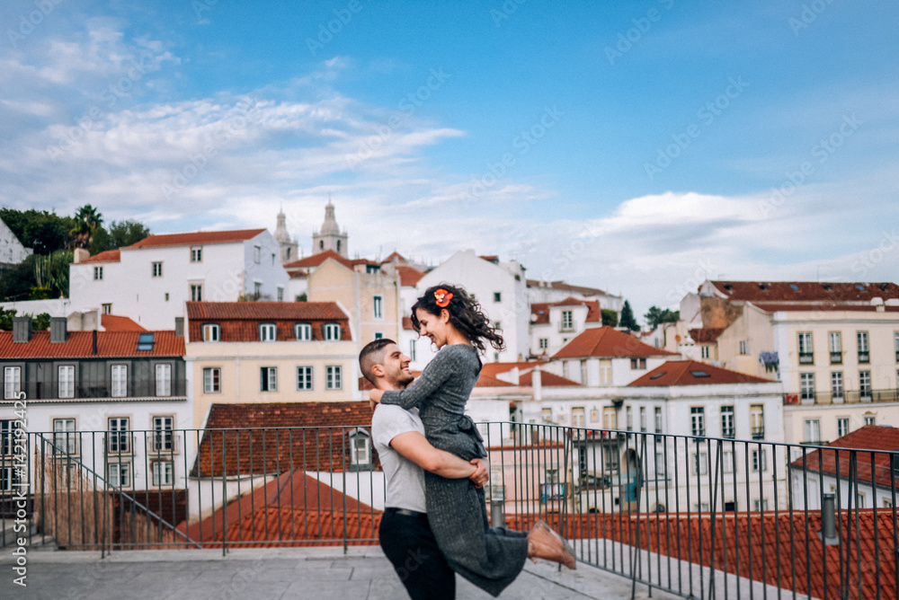 Couple has fun and laughs. kiss. Young hipster couple hugging each other in city. Kove story, a beautiful stylish young couple. Fashion concept with boyfriend and girlfriend in Lisboa