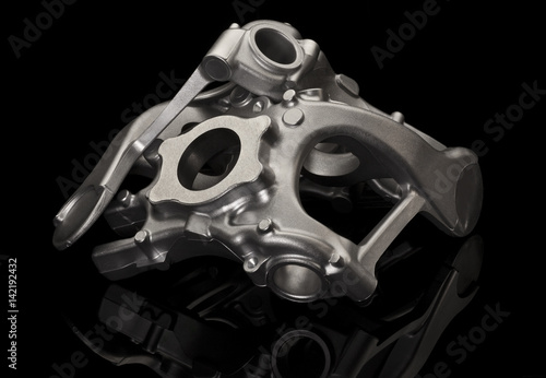 Metal car part over black background