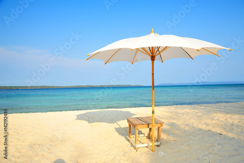 Fototapeta Naklejka Na Ścianę i Meble -  White Sand Beach with Beach Umbrella in Summer Season