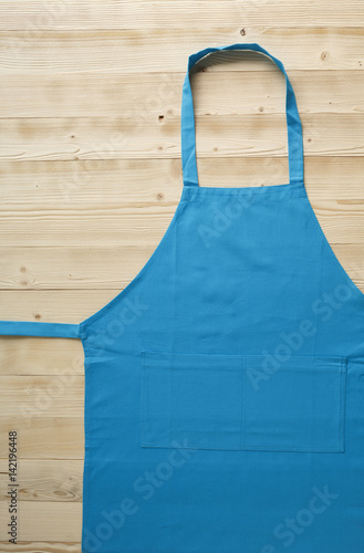 Wooden picnic table with blue apron on