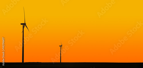 Wind turbines in orange sunset