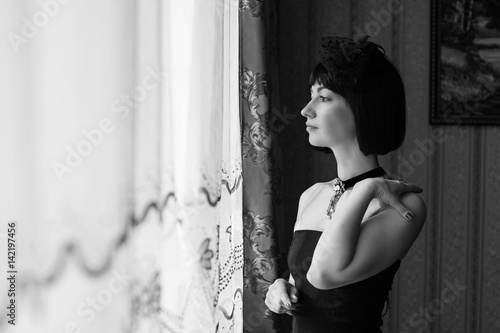 Fotografie Beautiful middle age woman with bob care hair in black theatre dress and vintage