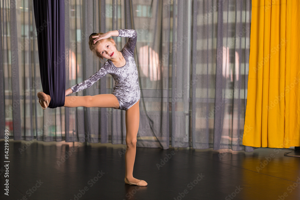 Fototapeta premium Little dancer in a aerial yoga hammock