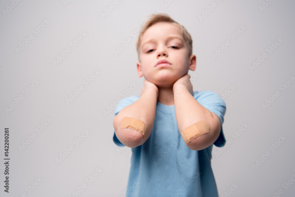 Little boy with patches on elbows Little boy with patches on elbows