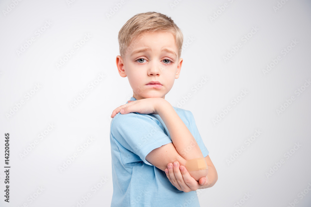 Little boy with patch on elbow Little boy with patch on elbow