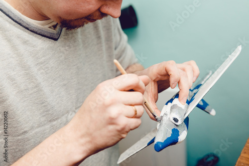 Aircraft on the radio control, the man paints the fuselage