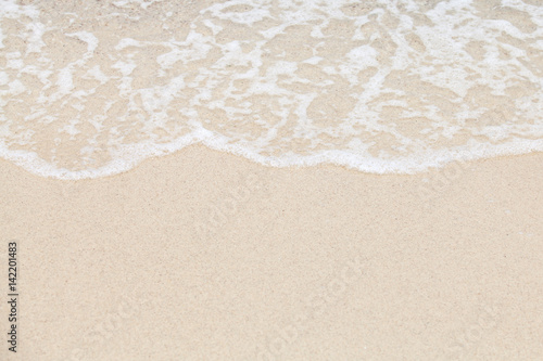 Soft wave of ocean on sandy beach. Background.