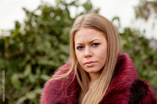 Pretty blonde girl with fur coat