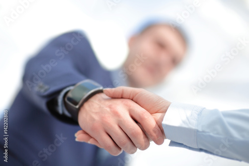 Close up view of business partnership handshake concept.Photo of two businessman handshaking process.Successful deal after great meeting.