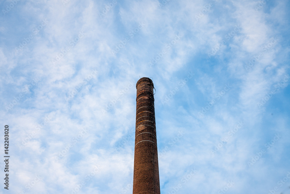 Red brick chimney from an abandoned factory dating back from the industrial revolution.