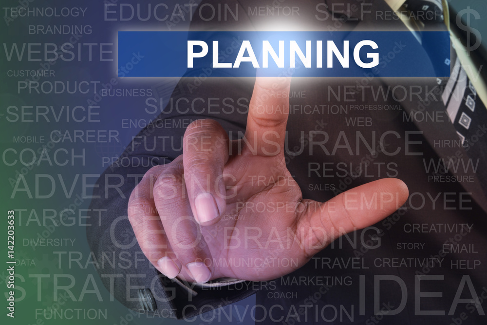 Businessman touching PLANNING button on virtual screen Businessman touching PLANNING button on virtual screen
